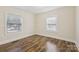 A bedroom with ample light, two windows, and beautiful hardwood floors at 603 Paradise St, Monroe, NC 28112