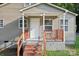 Close-up of the front entrance with brick steps and covered porch at 603 Paradise St, Monroe, NC 28112