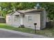 Single-story home with a covered entry, neat landscaping, and mailbox at 603 Paradise St, Monroe, NC 28112