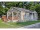 Charming single-story home featuring a covered front porch and mature trees at 603 Paradise St, Monroe, NC 28112