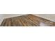 Close-up of rich, multi-toned hardwood flooring with vent in room at 603 Paradise St, Monroe, NC 28112