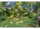 Secluded backyard featuring a grass lawn and surrounding mature trees that provide ample shade at 6632 Candlewood Dr, Charlotte, NC 28210