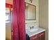 Powder Room features a red curtain at 6632 Candlewood Dr, Charlotte, NC 28210