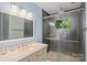 Updated bathroom with a modern glass enclosed shower and vanity with great lighting at 6632 Candlewood Dr, Charlotte, NC 28210