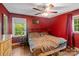 Cozy bedroom with hardwood floors, a ceiling fan, and ample natural light from the window at 6632 Candlewood Dr, Charlotte, NC 28210