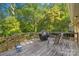 Outdoor deck with grill, seating, and lush green surroundings at 6632 Candlewood Dr, Charlotte, NC 28210