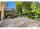 Back exterior view of house with a wide driveway, wooden decks, and a shady backyard at 6632 Candlewood Dr, Charlotte, NC 28210