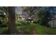 Exterior back of a brick house with a wooden deck overlooking the lush green backyard and path at 6632 Candlewood Dr, Charlotte, NC 28210