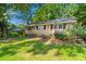 Beautiful brick home featuring manicured landscaping, walkway and lush greenery, adding to its appeal at 6632 Candlewood Dr, Charlotte, NC 28210