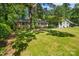 Spacious front yard with a brick home nestled amongst mature trees, offering a serene setting at 6632 Candlewood Dr, Charlotte, NC 28210