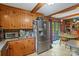 Bright kitchen with stainless steel refrigerator, eat in dining area, and access to the deck at 6632 Candlewood Dr, Charlotte, NC 28210
