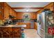 Well-maintained kitchen featuring wood cabinets, stainless steel appliances, and functional space at 6632 Candlewood Dr, Charlotte, NC 28210