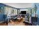 Bright living room boasts hardwood floors, large windows, and a modern entertainment setup at 6632 Candlewood Dr, Charlotte, NC 28210