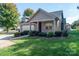 Charming exterior with stone and siding, complemented by a well-manicured lawn and inviting curb appeal at 860 Wynnshire Dr, Hickory, NC 28601