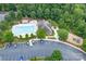 Aerial view of a community pool, clubhouse and parking area surrounded by trees at 8637 Annabel Lee Ln, Charlotte, NC 28277