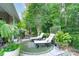 Relaxing backyard retreat with lounge chairs surrounded by lush greenery and plantings at 8637 Annabel Lee Ln, Charlotte, NC 28277