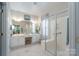 Bright bathroom featuring double sinks, generous vanity space, and a glass shower enclosure at 8637 Annabel Lee Ln, Charlotte, NC 28277