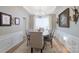 Elegant dining room with decorative chandelier, wainscoting, and ample seating at 8637 Annabel Lee Ln, Charlotte, NC 28277