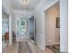 Welcoming foyer features an open front door, light wood floors, and detailed trim work at 8637 Annabel Lee Ln, Charlotte, NC 28277