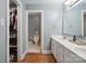 Bathroom featuring a double vanity sink, mirror, and walk-in closet at 9605 Mountain Ivy Ct, Charlotte, NC 28210
