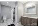 Cozy bathroom featuring hexagon tiled floor, walk in shower, and a gray vanity at 9605 Mountain Ivy Ct, Charlotte, NC 28210