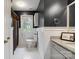 Charming bathroom featuring dark blue walls, a decorative mirror, and white vanity at 9605 Mountain Ivy Ct, Charlotte, NC 28210