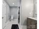 Cozy bathroom featuring hexagon tiled floor, walk in shower, and a gray vanity at 9605 Mountain Ivy Ct, Charlotte, NC 28210