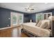 Comfortable bedroom with hardwood floors, ceiling fan, french doors and a built-in closet at 9605 Mountain Ivy Ct, Charlotte, NC 28210