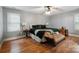 Comfortable bedroom featuring hardwood floors, ceiling fan, and natural light from the window at 9605 Mountain Ivy Ct, Charlotte, NC 28210