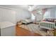 Bright bedroom featuring two single beds, hardwood floors, and natural light at 9605 Mountain Ivy Ct, Charlotte, NC 28210
