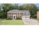 Traditional two-story brick home with black shutters, dormers and a well-manicured lawn at 9605 Mountain Ivy Ct, Charlotte, NC 28210