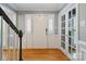 Bright foyer features hardwood floors, white trim, and a stairway with a black handrail at 9605 Mountain Ivy Ct, Charlotte, NC 28210