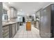 Bright kitchen with gray cabinets, an island, stainless steel appliances, and white tile floors at 9605 Mountain Ivy Ct, Charlotte, NC 28210
