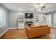 Comfortable living room with a fireplace, hardwood floors, and built in cabinets at 9605 Mountain Ivy Ct, Charlotte, NC 28210