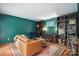 Inviting living room with emerald walls, hardwood floors, and stylish furnishings, perfect for relaxing and entertaining at 9605 Mountain Ivy Ct, Charlotte, NC 28210