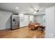 Living space featuring stainless steel refrigerator, wet bar, and comfortable sitting area at 9605 Mountain Ivy Ct, Charlotte, NC 28210