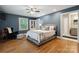 Bedroom features hardwood floors, a ceiling fan, and an ensuite bathroom at 9605 Mountain Ivy Ct, Charlotte, NC 28210