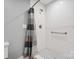 Walk-in shower with white subway tile, accessible grab bar, and pattern tiled floor at 9605 Mountain Ivy Ct, Charlotte, NC 28210