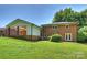 Exterior view of the home showcasing a spacious backyard with a covered patio at 1008 Dumbarton Rd, Gastonia, NC 28054