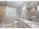 Updated bathroom featuring granite countertop, tiled shower, and plantation shutters at 1008 Dumbarton Rd, Gastonia, NC 28054