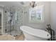 Bathroom features a glass shower and a soaking tub at 1008 Dumbarton Rd, Gastonia, NC 28054