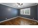 Cozy bedroom with hardwood floors, neutral walls, plantation shutters, and ceiling fan at 1008 Dumbarton Rd, Gastonia, NC 28054