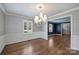 Formal dining room with hardwood floors, decorative chandelier, and white wainscoting at 1008 Dumbarton Rd, Gastonia, NC 28054