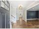 Welcoming foyer with hardwood floors, staircase, and elegant light fixture at 1008 Dumbarton Rd, Gastonia, NC 28054