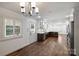 Open kitchen featuring a door to the backyard, eat-in dining area, stainless steel appliances, and hardwood floors at 1008 Dumbarton Rd, Gastonia, NC 28054