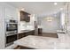 Spacious kitchen featuring stainless steel appliances, double oven, marble countertops and backsplash, and modern fixtures at 1008 Dumbarton Rd, Gastonia, NC 28054