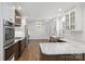Bright and open kitchen features marble counters, stainless appliances, and contrasting dark and white cabinetry at 1008 Dumbarton Rd, Gastonia, NC 28054