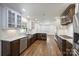 Bright open kitchen with marble countertops, stainless steel appliances, windowed cabinets and hardwood floors at 1008 Dumbarton Rd, Gastonia, NC 28054