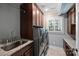 Well-organized laundry room with modern machines, sink, granite countertops, and ample cabinet space at 1008 Dumbarton Rd, Gastonia, NC 28054