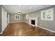 Spacious living room with fireplace, plantation shutters, and hardwood floors at 1008 Dumbarton Rd, Gastonia, NC 28054